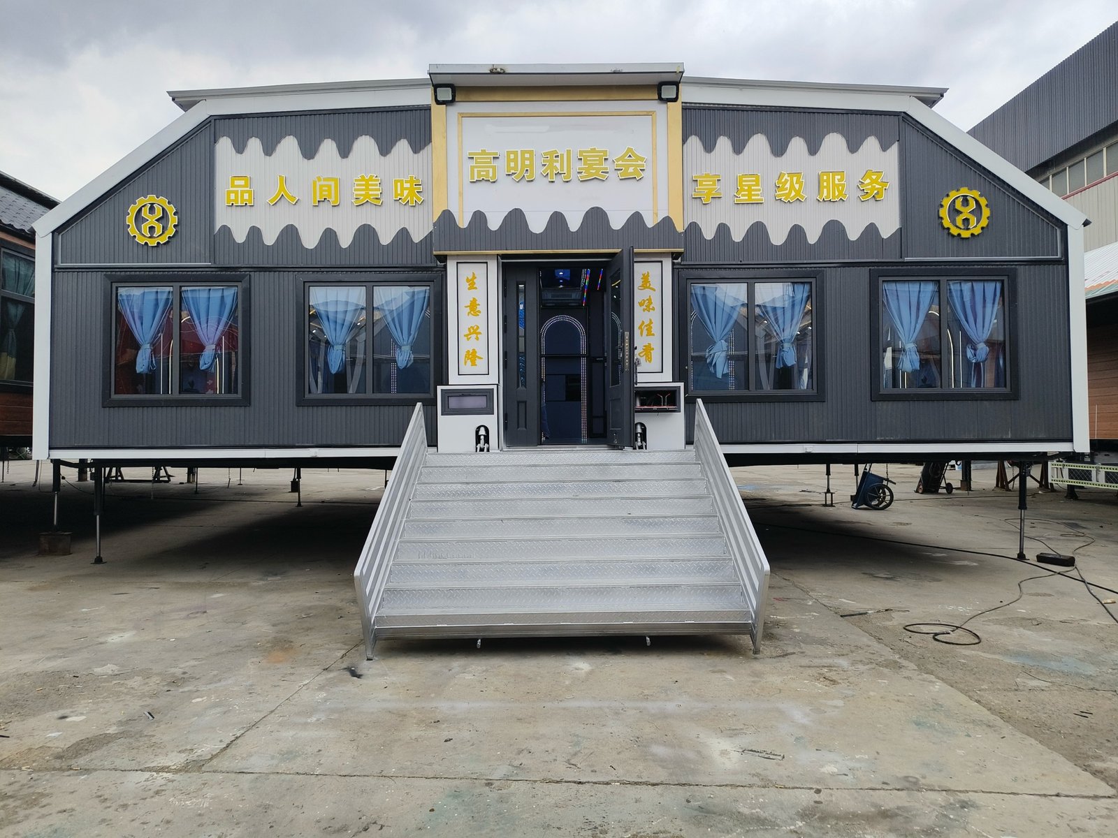MB160 mobile banquet hall deployed on a paved site with steps and support legs